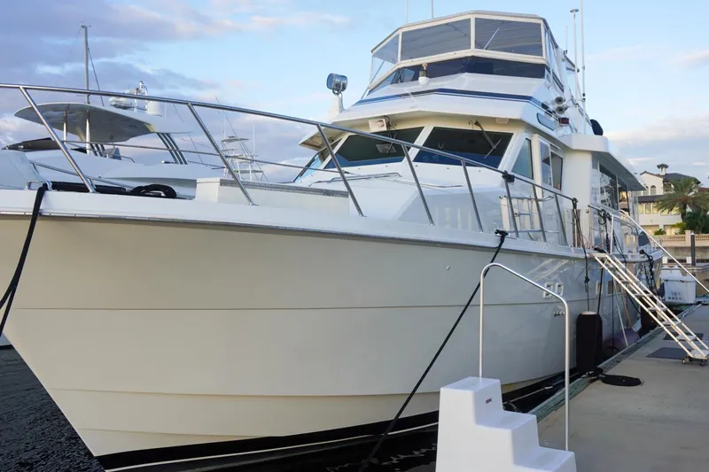 Sunset Grille Yacht Photos Pics 1990 Hatteras 62 Cockpit Motor Yacht docked at marina under blue sky.