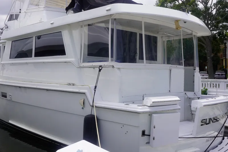 Sunset Grille Yacht Photos Pics 1990 Hatteras 62 Cockpit Motor Yacht docked, featuring spacious deck and sleek design.