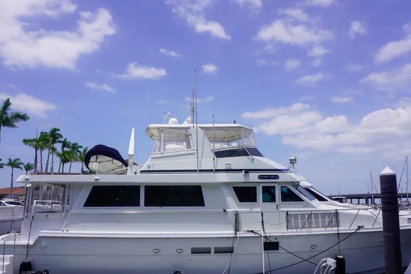 Sunset Grille Yacht Photos Pics 1990 Hatteras 62 Cockpit Motor Yacht docked under a clear blue sky.