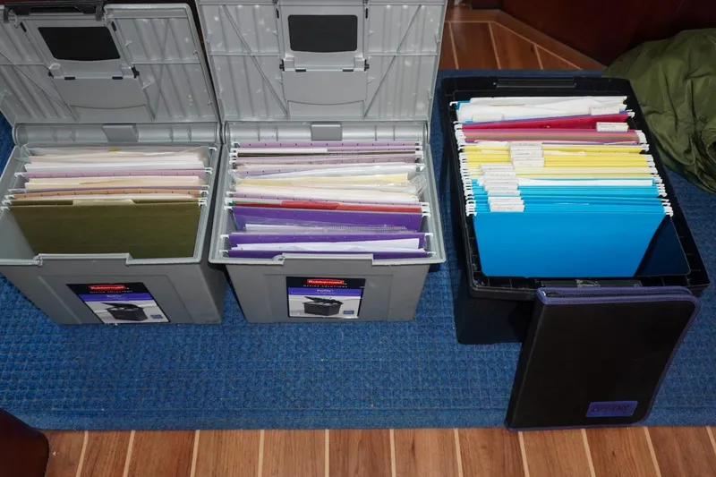 Sunset Grille Yacht Photos Pics Organized file boxes with documents on a Hatteras 62 Cockpit Motor Yacht, 1990 model.