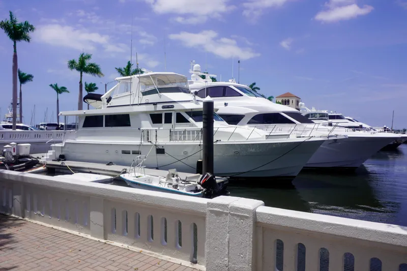Sunset Grille Yacht Photos Pics 1990 Hatteras 62 Cockpit Motor Yacht docked at marina under blue sky.