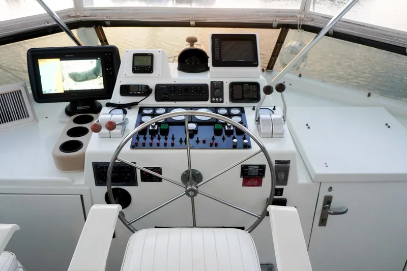 Sunset Grille Yacht Photos Pics Cockpit of 1990 Hatteras 62 Cockpit Motor Yacht with navigation instruments and steering wheel.