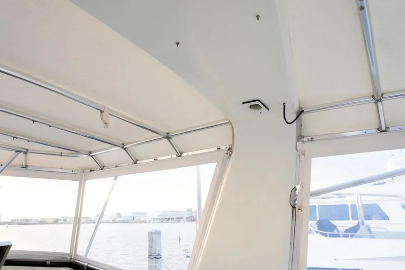 Sunset Grille Yacht Photos Pics Interior view of 1990 Hatteras 62 Cockpit Motor Yacht, featuring windows and metal framework.