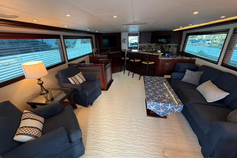 Sunset Grille Yacht Photos Pics Luxurious interior of 1990 Hatteras 62 Cockpit Motor Yacht with elegant seating and modern decor.
