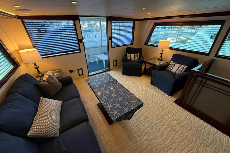 Sunset Grille Yacht Photos Pics Luxurious interior of 1990 Hatteras 62 Cockpit Motor Yacht with elegant seating and decor.