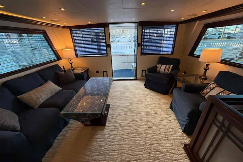 Sunset Grille Yacht Photos Pics Luxurious interior of 1990 Hatteras 62 Cockpit Motor Yacht with elegant seating and decor.