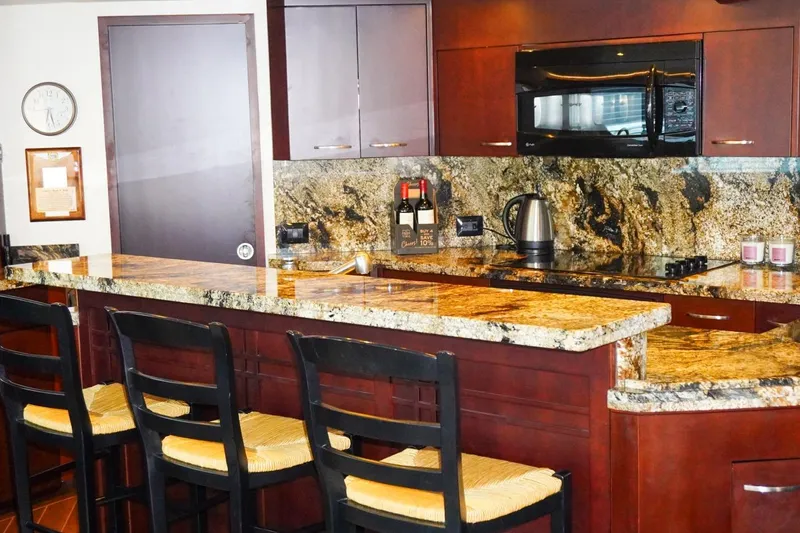 Sunset Grille Yacht Photos Pics Luxurious kitchen interior on 1990 Hatteras 62 Cockpit Motor Yacht with granite countertops.