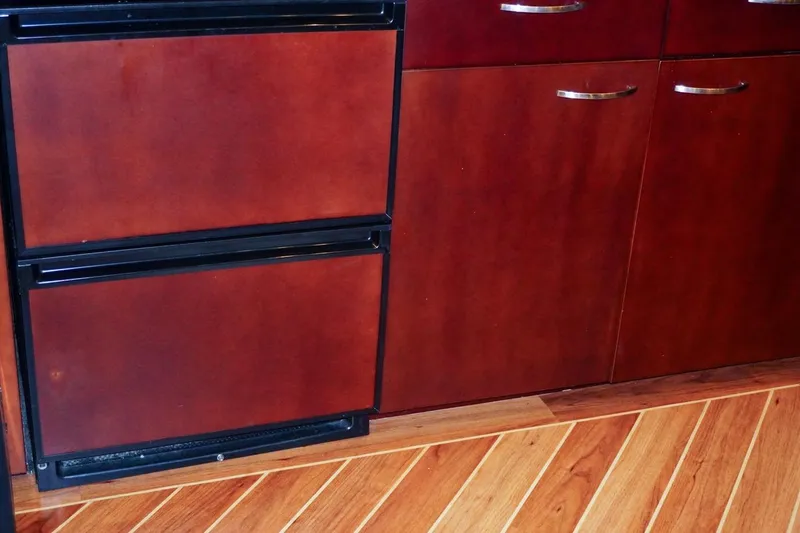 Sunset Grille Yacht Photos Pics Wooden cabinetry and flooring in 1990 Hatteras 62 Cockpit Motor Yacht interior.