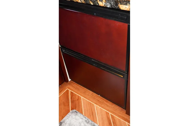 Sunset Grille Yacht Photos Pics Interior of 1990 Hatteras 62 Cockpit Motor Yacht with wood paneling and granite countertop.