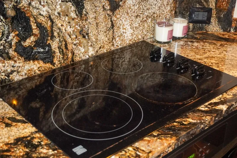 Sunset Grille Yacht Photos Pics Granite countertop with electric cooktop on 1990 Hatteras 62 Cockpit Motor Yacht.