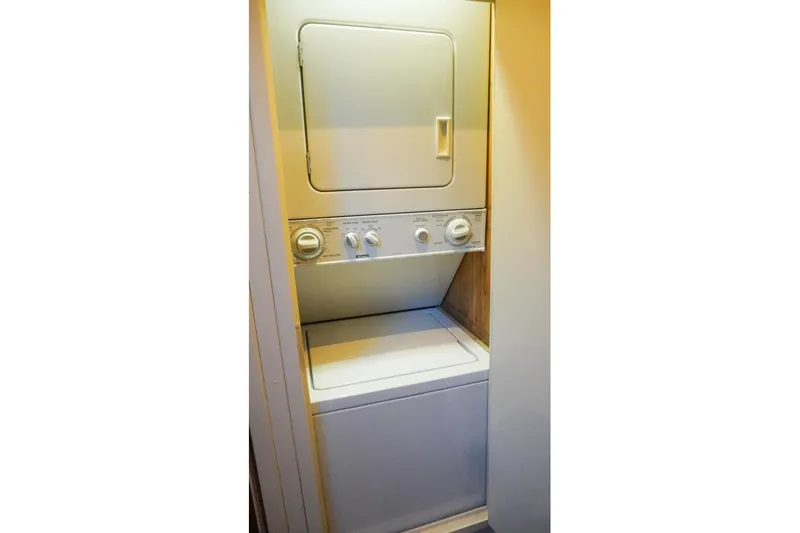 Sunset Grille Yacht Photos Pics Stacked washer and dryer unit inside 1990 Hatteras 62 Cockpit Motor Yacht.