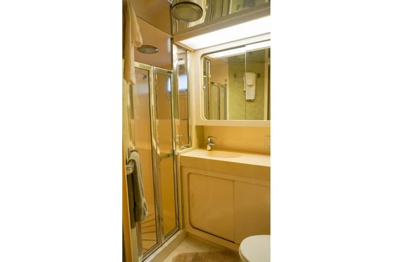 Sunset Grille Yacht Photos Pics Bathroom interior of 1990 Hatteras 62 Cockpit Motor Yacht with shower and sink.