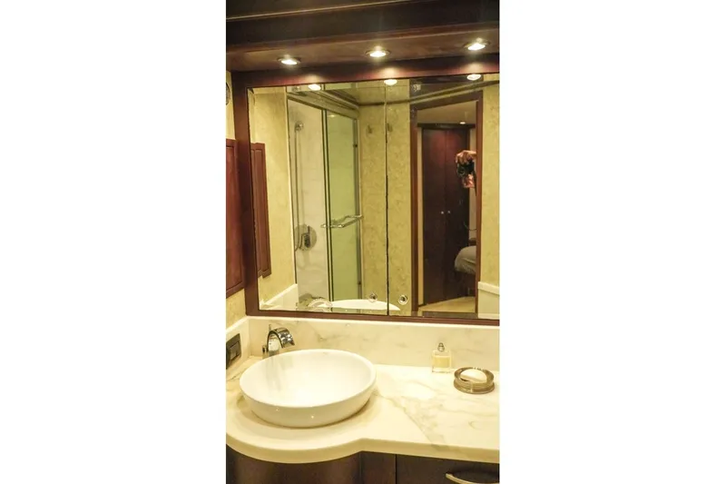 Sunset Grille Yacht Photos Pics Luxurious bathroom interior of 1990 Hatteras 62 Cockpit Motor Yacht with modern fixtures.