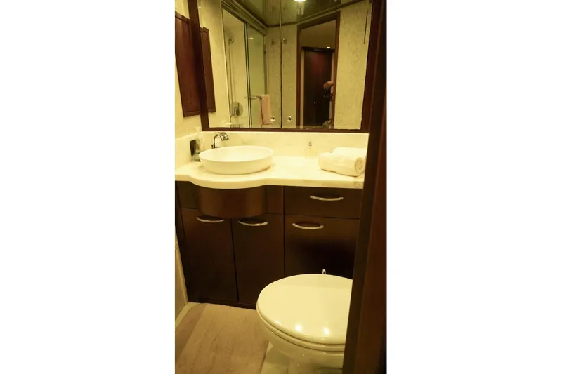 Sunset Grille Yacht Photos Pics Bathroom interior of 1990 Hatteras 62 Cockpit Motor Yacht with modern fixtures.