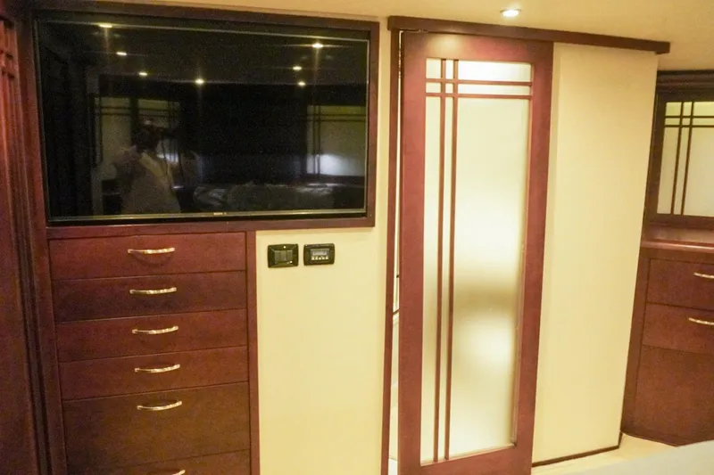 Sunset Grille Yacht Photos Pics Luxurious interior of 1990 Hatteras 62 Cockpit Motor Yacht with TV and elegant cabinetry.