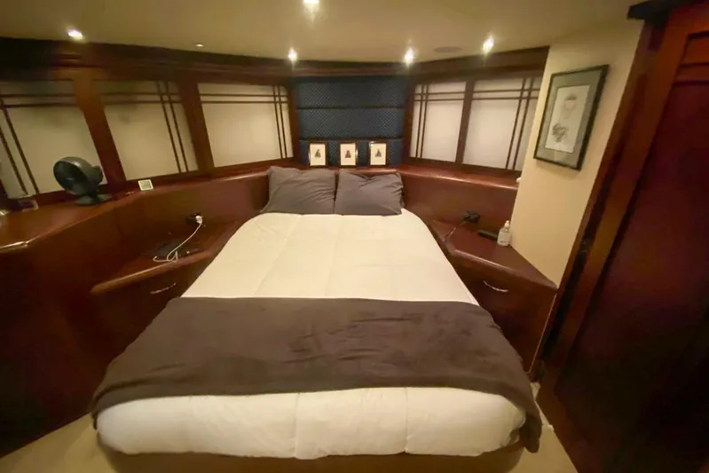Sunset Grille Yacht Photos Pics Luxurious bedroom interior of 1990 Hatteras 62 Cockpit Motor Yacht with cozy bedding.