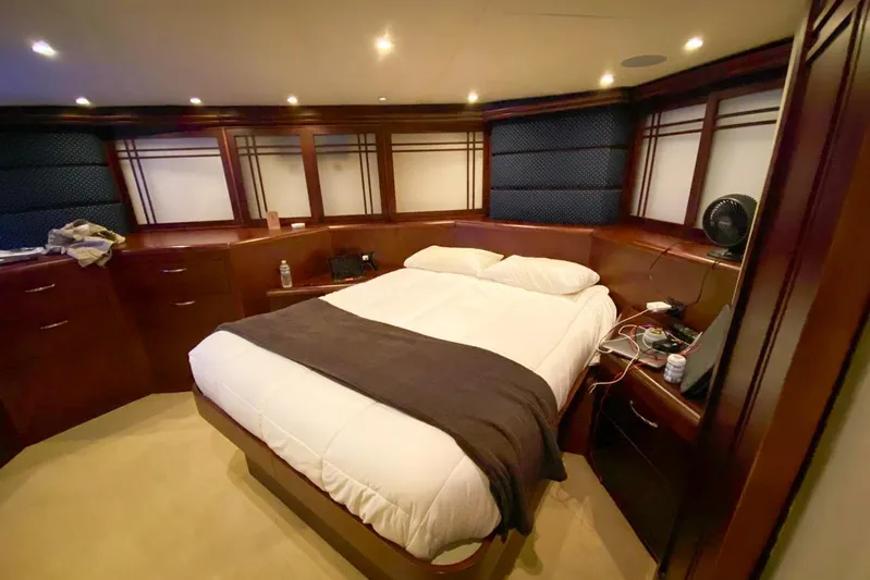 Sunset Grille Yacht Photos Pics Luxurious bedroom interior of 1990 Hatteras 62 Cockpit Motor Yacht with elegant wood finishes.