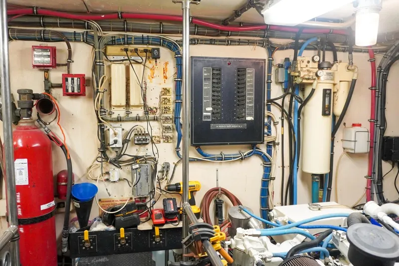 Sunset Grille Yacht Photos Pics Engine room of 1990 Hatteras 62 Cockpit Motor Yacht with electrical panels and equipment.