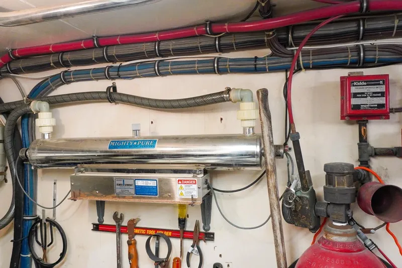 Sunset Grille Yacht Photos Pics Engine room of 1990 Hatteras 62 Cockpit Motor Yacht with water purifier and tools.