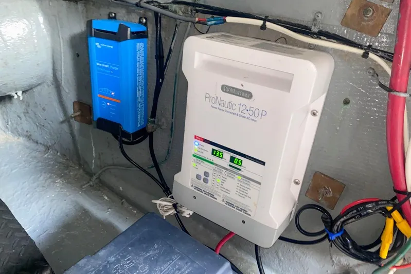 Sunset Grille Yacht Photos Pics Electrical system inside a 1990 Hatteras 62 Cockpit Motor Yacht, featuring ProNautic charger.