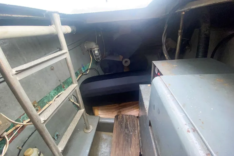 Sunset Grille Yacht Photos Pics Engine room of 1990 Hatteras 62 Cockpit Motor Yacht with ladder and equipment.