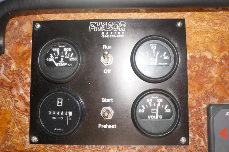 Sunset Grille Yacht Photos Pics Control panel of a 1990 Hatteras 62 Cockpit Motor Yacht with gauges and switches.