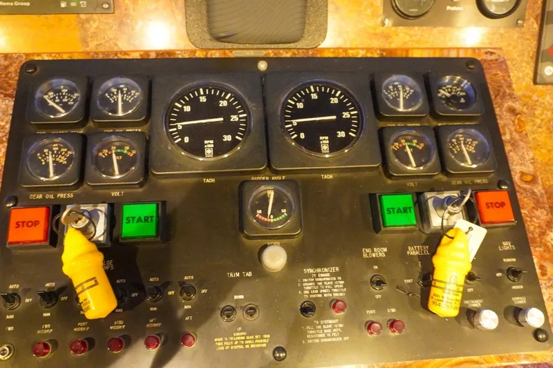 Sunset Grille Yacht Photos Pics Control panel of a 1990 Hatteras 62 Cockpit Motor Yacht with gauges and switches.