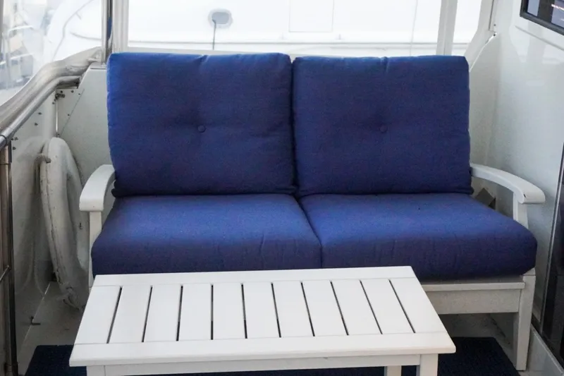 Sunset Grille Yacht Photos Pics Blue cushioned seating on 1990 Hatteras 62 Cockpit Motor Yacht deck.