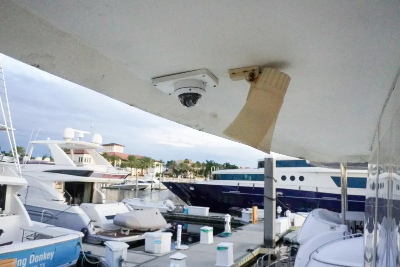 Sunset Grille Yacht Photos Pics 1990 Hatteras 62 Cockpit Motor Yacht docked at marina with security camera.