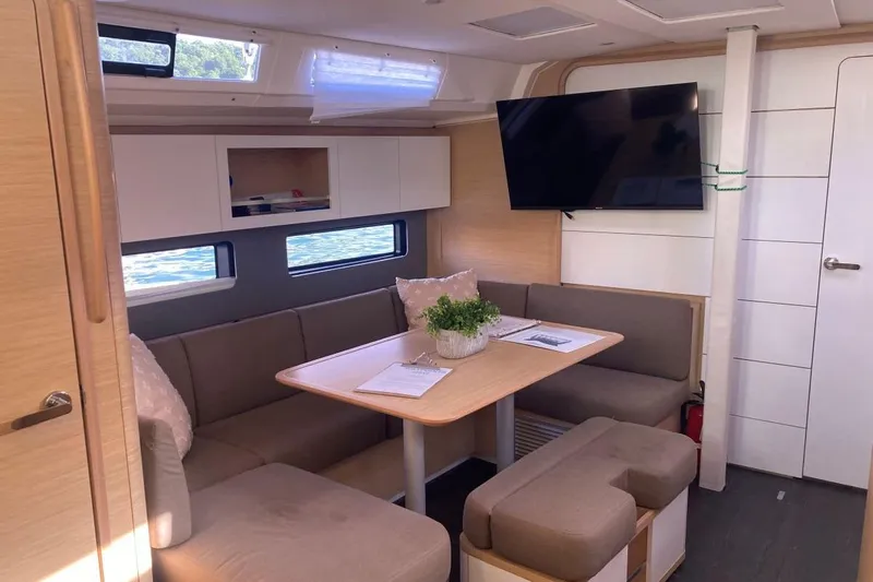 Seabreeze Smile Yacht Photos Pics Modern interior of 2023 Dufour 41 yacht with cozy seating and TV.
