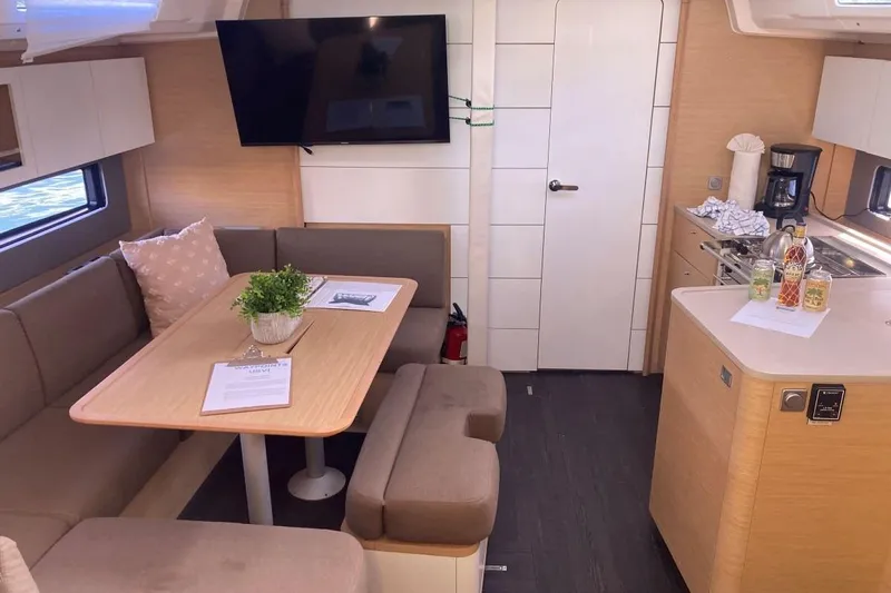 Seabreeze Smile Yacht Photos Pics Modern interior of 2023 Dufour 41 yacht with dining area and kitchenette.