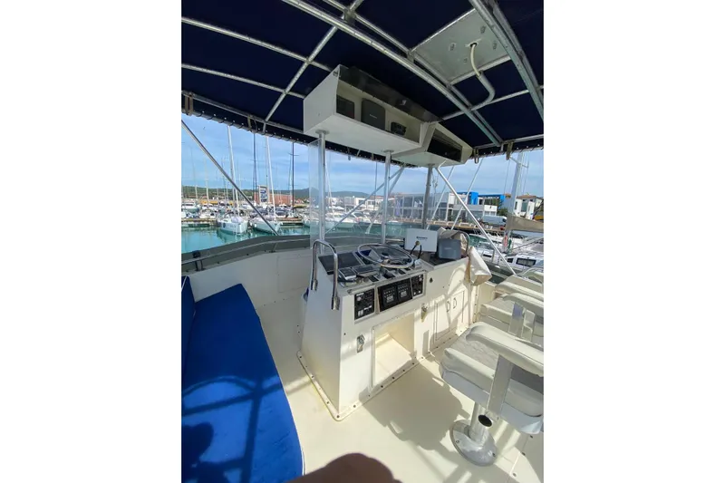  Yacht Photos Pics 1990 Hatteras 41 Convertible yacht cockpit with blue canopy and marina view.