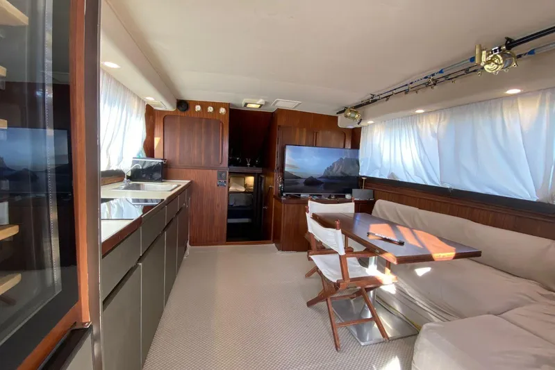  Yacht Photos Pics Interior of 1990 Hatteras 41 Convertible yacht with modern kitchen and cozy seating area.