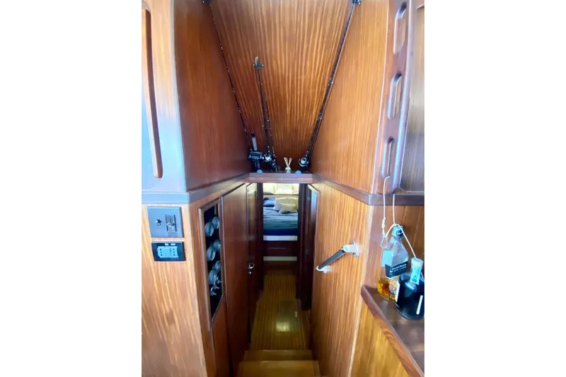  Yacht Photos Pics Interior of 1990 Hatteras 41 Convertible yacht with wooden paneling and fishing rods.