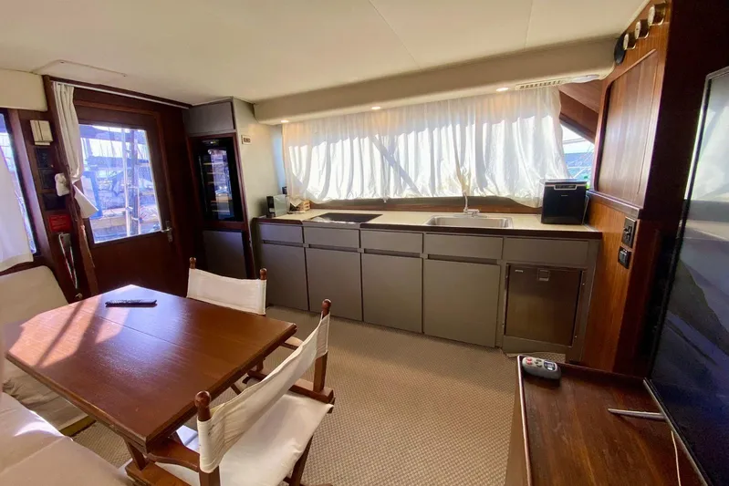  Yacht Photos Pics Interior of 1990 Hatteras 41 Convertible yacht with kitchen and dining area.