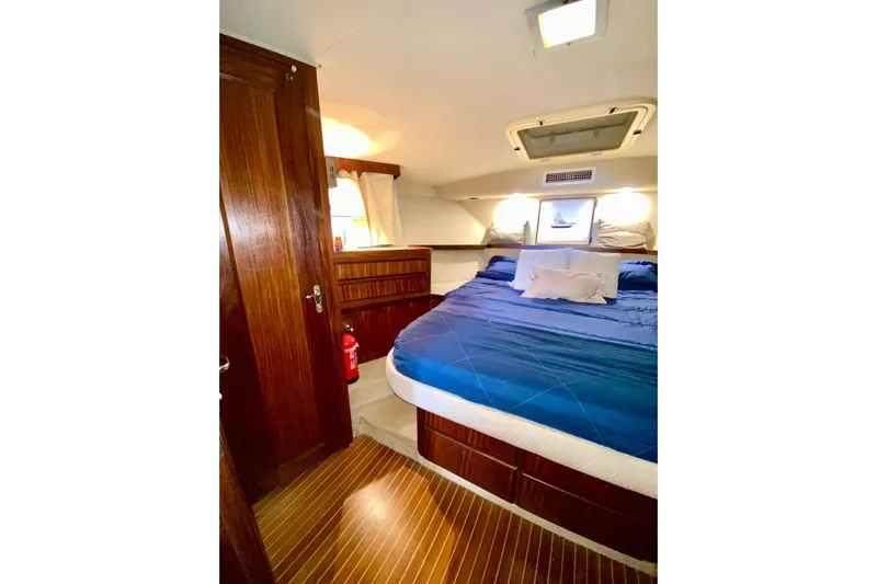  Yacht Photos Pics Luxurious cabin interior of 1990 Hatteras 41 Convertible yacht with cozy bedding.