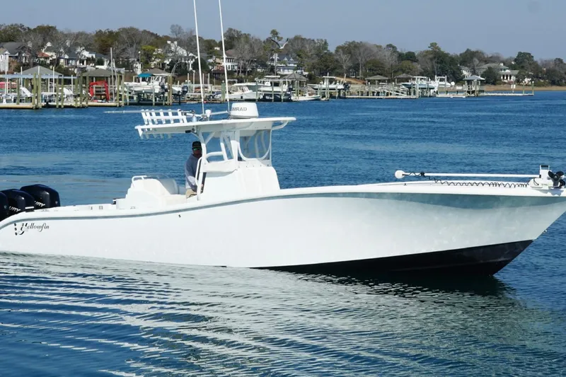  Yacht Photos Pics 2007 Yellowfin 36 Offshore boat cruising on a calm blue waterway.