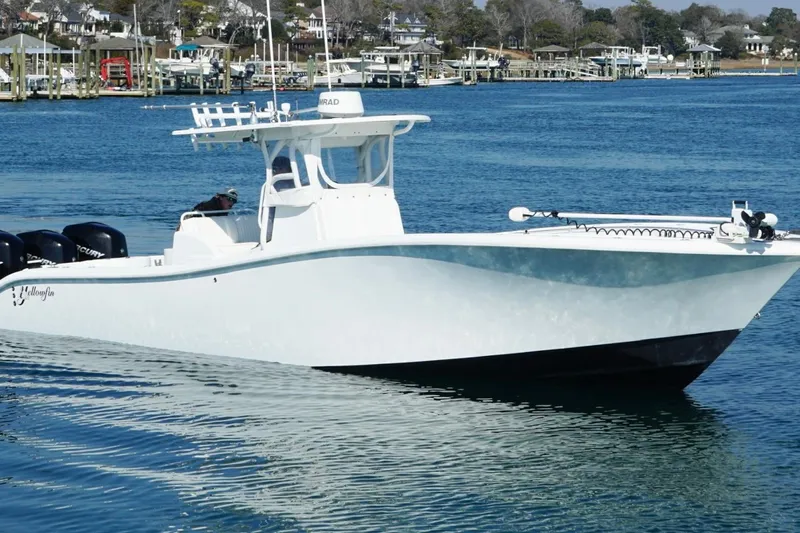  Yacht Photos Pics 2007 Yellowfin 36 Offshore boat on calm water near a marina.
