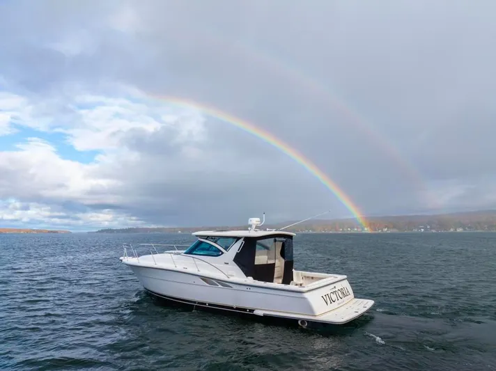  Yacht Photos Pics 2004 Tiara Yachts 3800 Open on water with double rainbow in background.