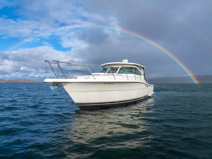  Yacht Photos Pics 2004 Tiara Yachts 3800 Open on water with a rainbow in the background.