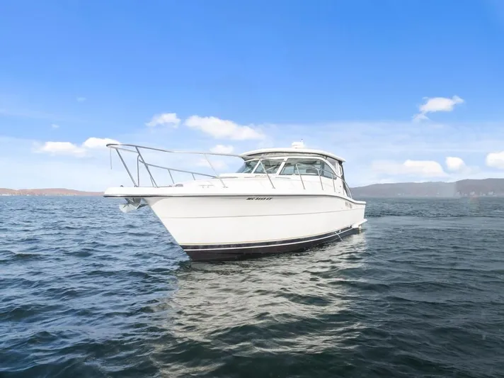  Yacht Photos Pics 2004 Tiara Yachts 3800 Open cruising on a calm sea under a clear blue sky.