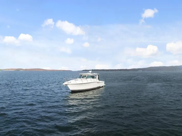  Yacht Photos Pics 2004 Tiara Yachts 3800 Open cruising on a calm, scenic lake.