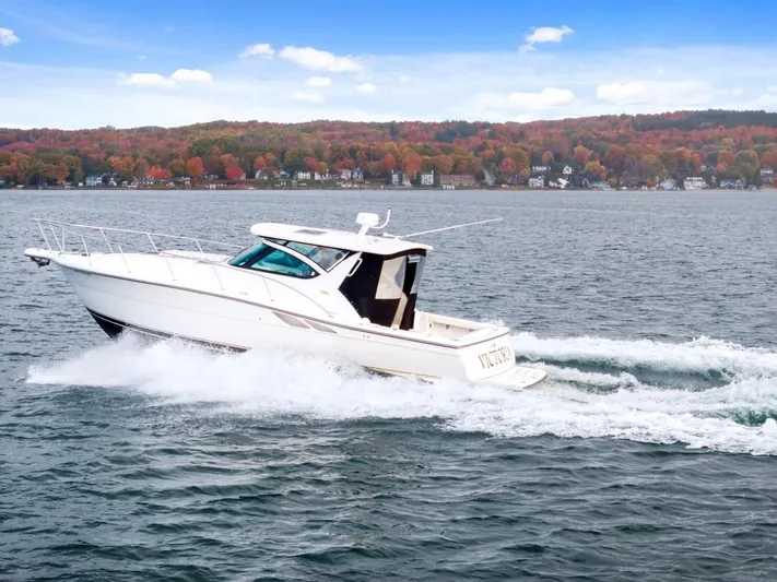  Yacht Photos Pics 2004 Tiara Yachts 3800 Open cruising on a scenic lake with autumn foliage.