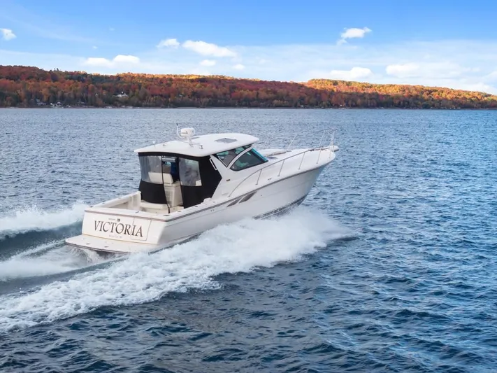  Yacht Photos Pics 2004 Tiara Yachts 3800 Open cruising on a lake with autumn foliage backdrop.