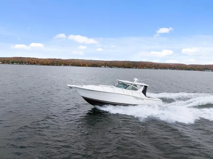  Yacht Photos Pics 2004 Tiara Yachts 3800 Open cruising on a lake with autumn foliage in the background.