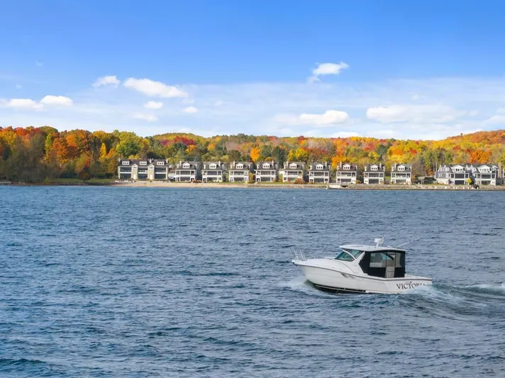  Yacht Photos Pics 2004 Tiara Yachts 3800 Open cruising on a lake with autumn foliage and waterfront homes.
