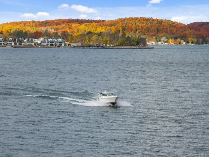  Yacht Photos Pics Tiara Yachts 2004 3800 Open cruising on a lake with vibrant autumn foliage.