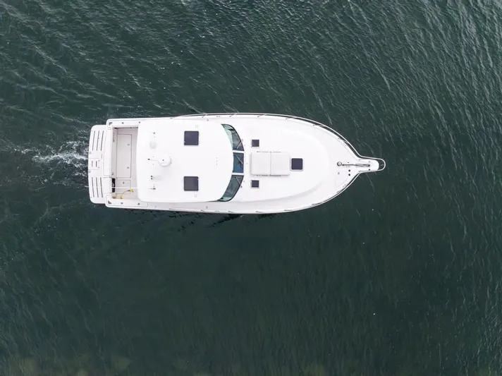  Yacht Photos Pics Aerial view of 2004 Tiara Yachts 3800 Open cruising on water.