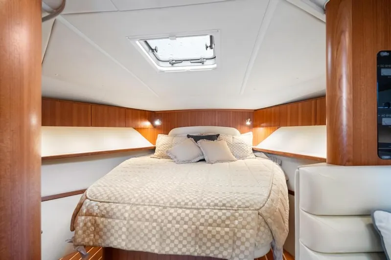  Yacht Photos Pics Luxurious cabin interior of 2004 Tiara Yachts 3800 Open with cozy bedding.