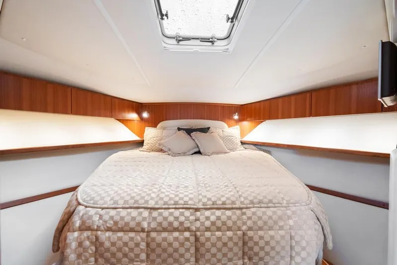  Yacht Photos Pics Luxurious cabin interior of 2004 Tiara Yachts 3800 Open with cozy bedding.